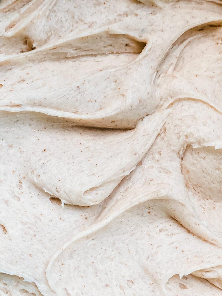 A close-up of swirls of brown butter cream cheese frosting.
