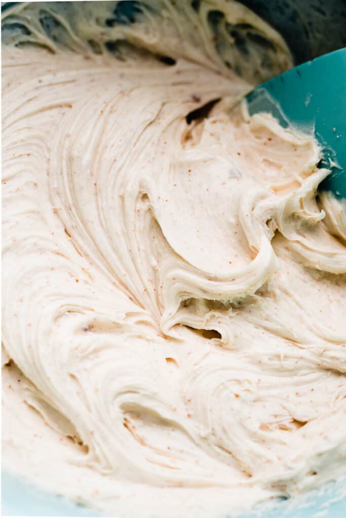 A close-up of swirls of brown butter cream cheese frosting.