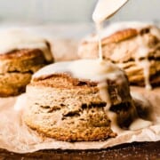 These Maple Biscuits are the perfect cozy brunch bake! They're extra tall and flaky, with crisp edges, pillowy soft insides, and tons of maple flavor from real maple syrup. Top them with a buttery maple glaze for ultimate fall bliss. #biscuits #buttermilkbiscuits #maplebiscuits #maple #fallbaking #fallbrunch #fallbreakfast #fallrecipes #comfortfood #breakfastrecipes #brunchrecipes #makeaheadbrunch #bluebowlrecipes | bluebowlrecipes.com