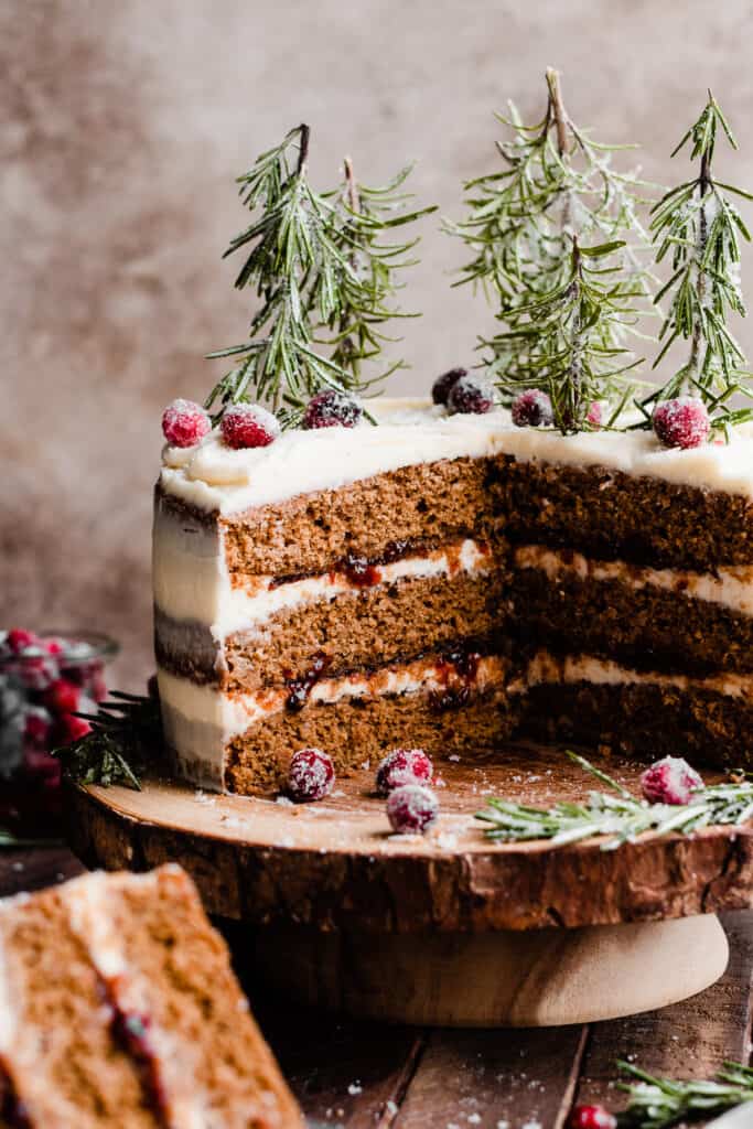 A close-up of the sliced open cake, with layers of cranberry jam and frosting visible.