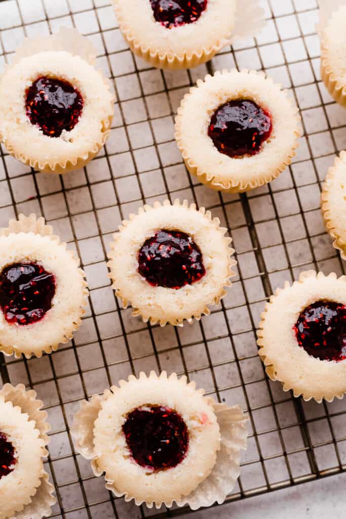 Cupcakes being filled with preserves.