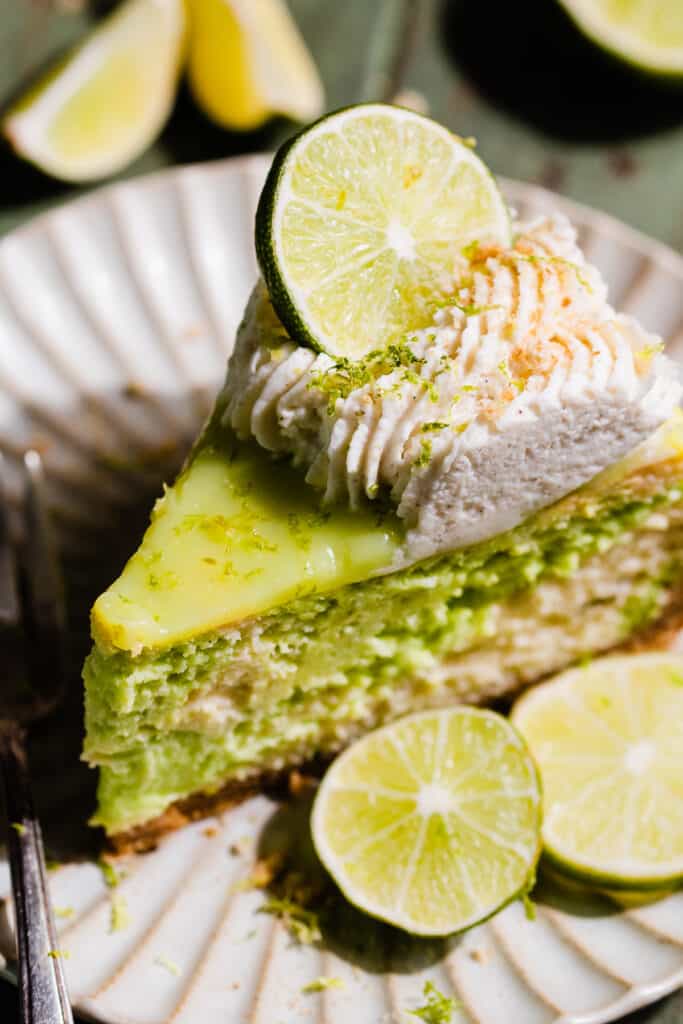 A close-up on a slice of the cheesecake on a plate.