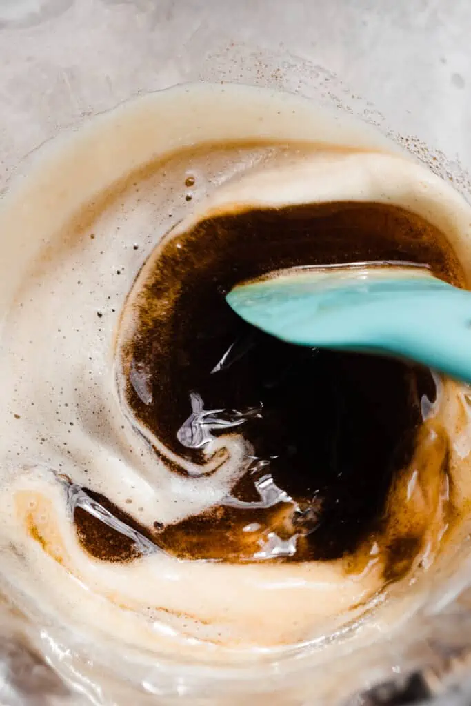 Browning butter in a skillet, stirring with blue spatula.