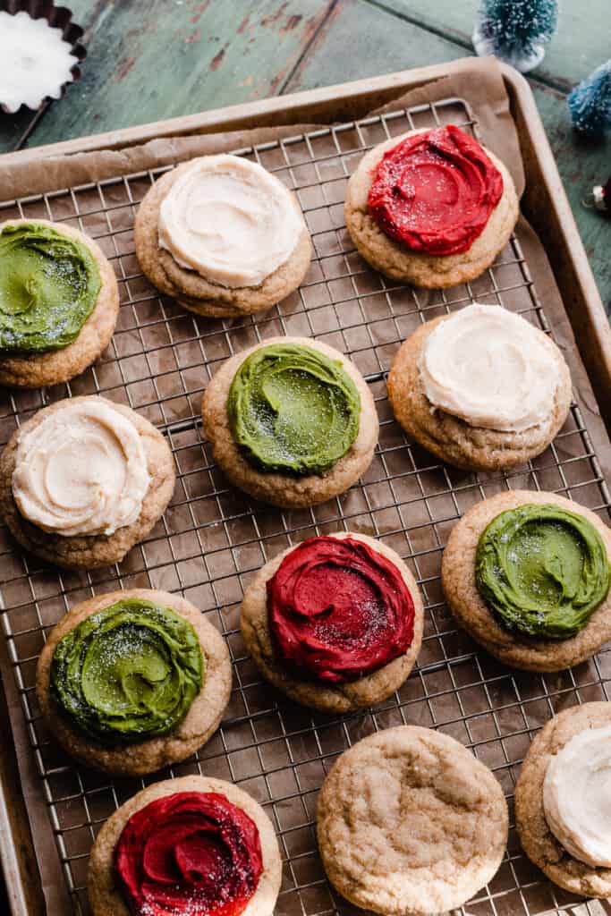 A cooling rack with the frosted sour cream cookies.