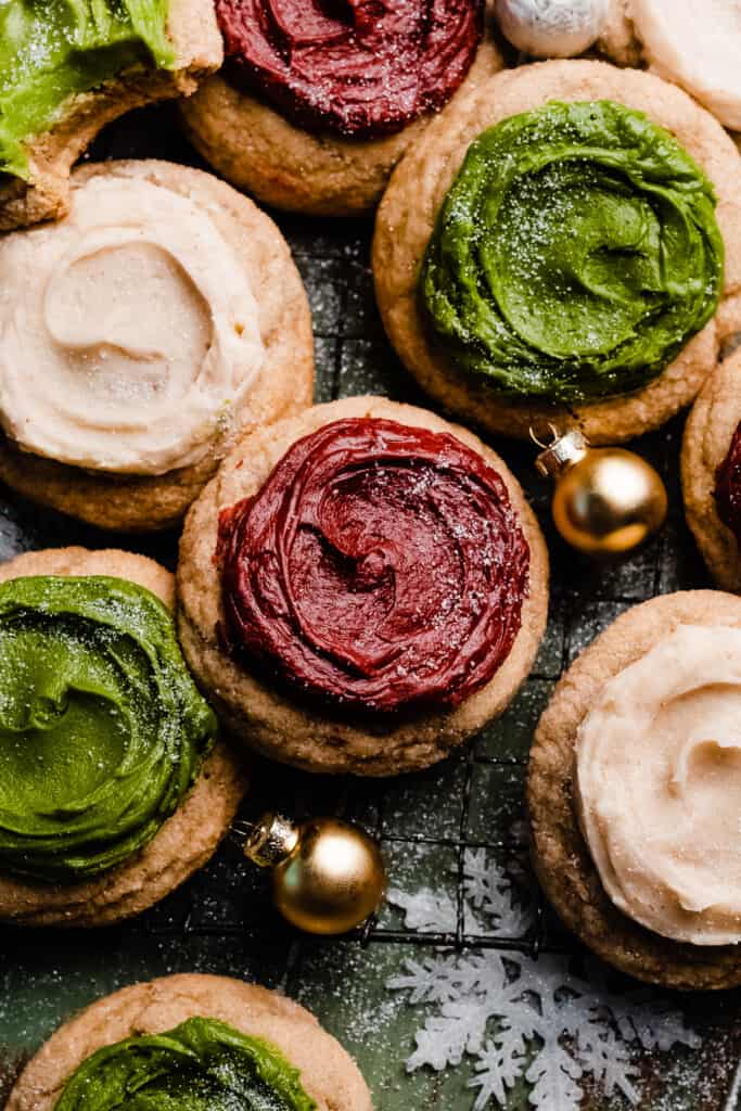 The frosted sour cream cookies on a vintage wire rack.