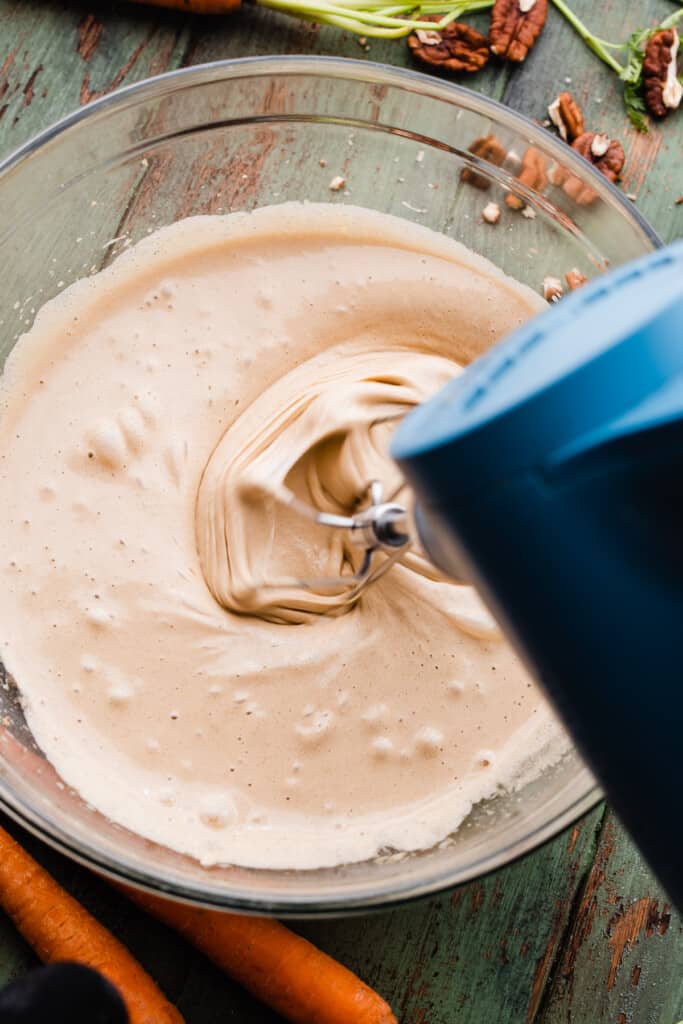 A mixer beating together the eggs and sugar.