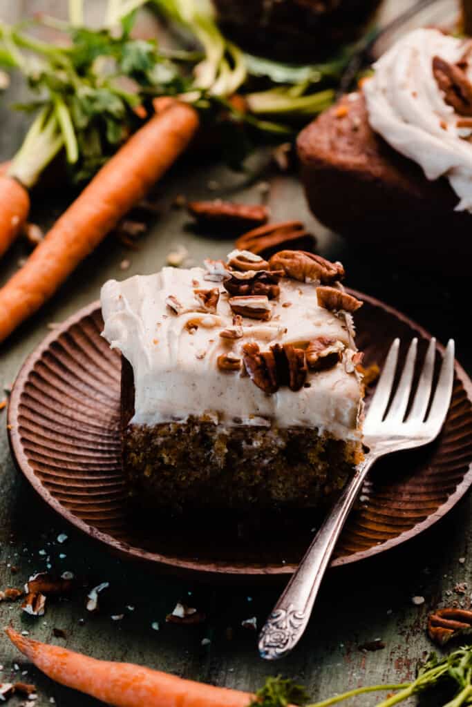 A slice of mini carrot cake on a cake plate.