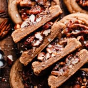 The halves of four pecan pie cookies, stacked, to show the chewy insides and pecan pie filling.