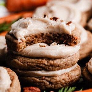 A stack of frosted carrot cake cookies.