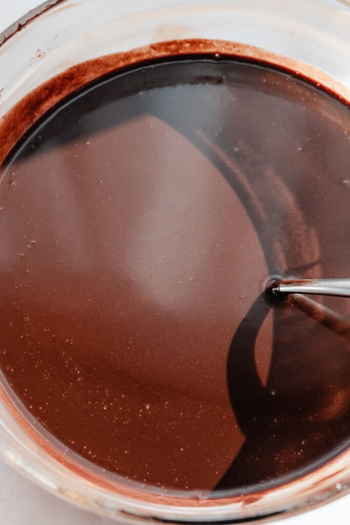 A bowl of the melted chocolate, water, and corn syrup.