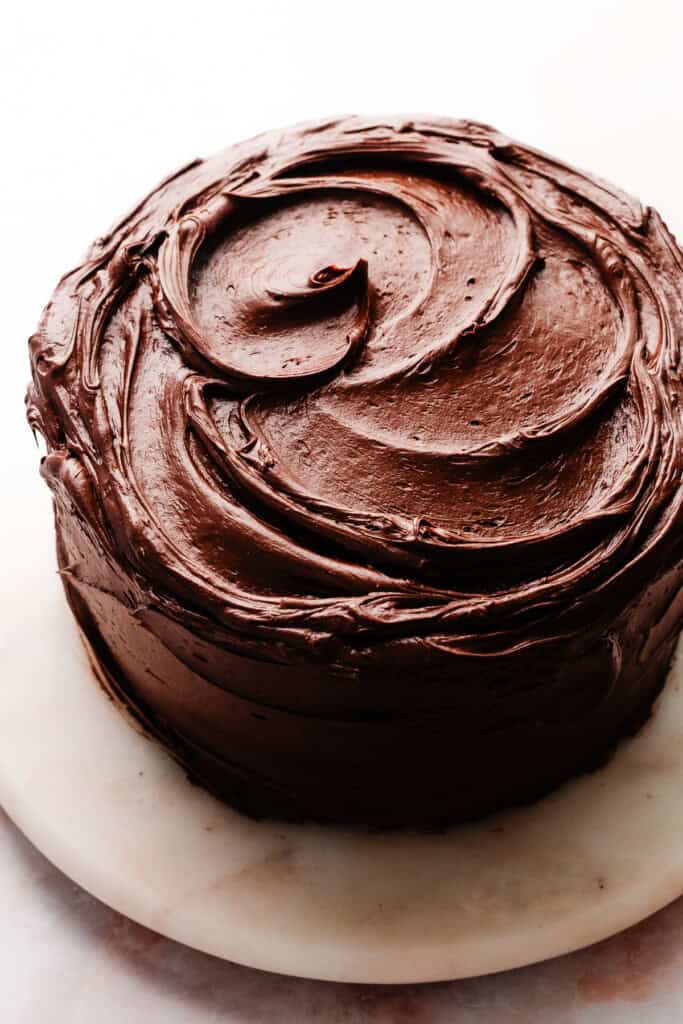 A chocolate cake, covered in luscious swirls of the frosting.