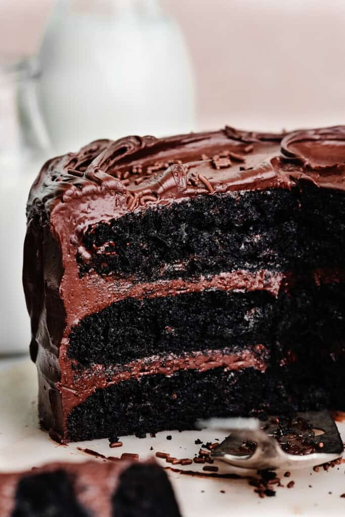 A close-up on the inside of a three layer chocolate cake, frosted with this chocolate fudge frosting.