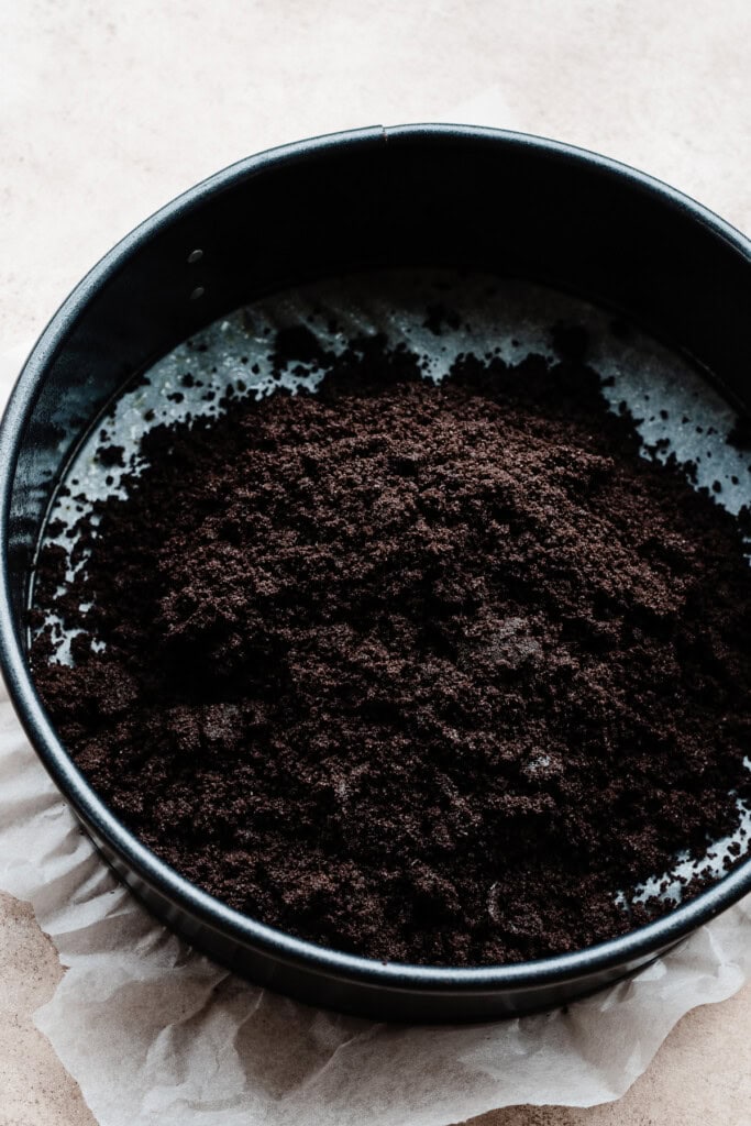 The crushed oreo and melted butter crust mixture.