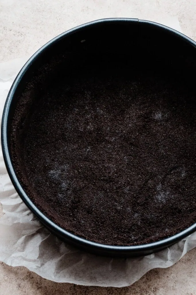 The baked chocolate crust in a springform pan.
