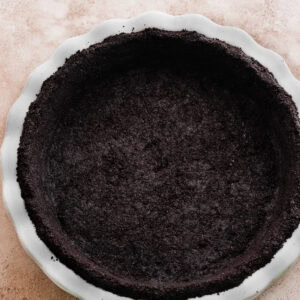 A baked oreo crust in a 9-inch pie dish.