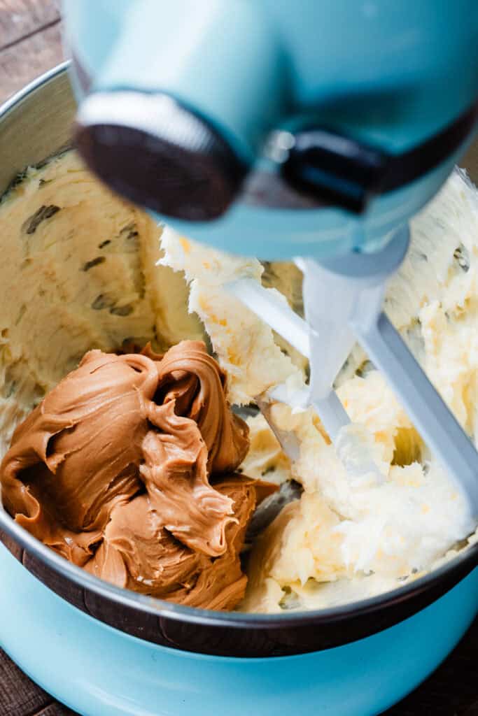 Peanut butter added to the bowl of butter.