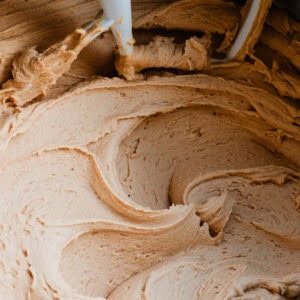 Luscious peanut butter frosting in the bowl of a stand mixer.