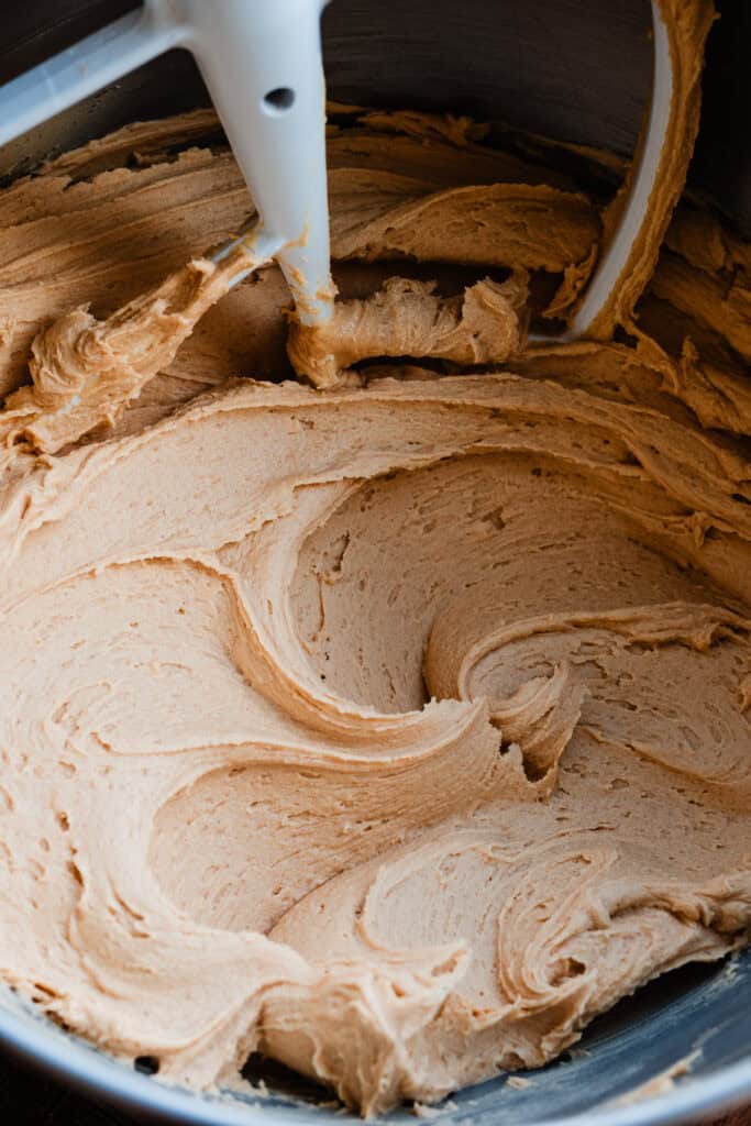 Peanut butter frosting in a stand mixer bowl.