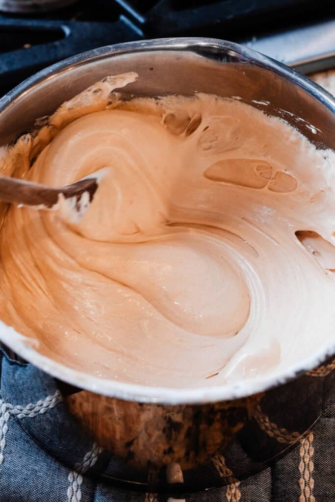 The peanut butter fudge mixture being stirred in the pot.