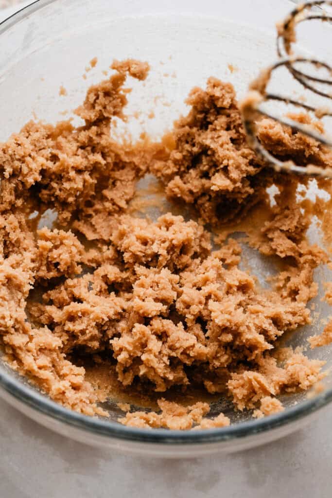 A bowl of creamed butter and brown sugar.