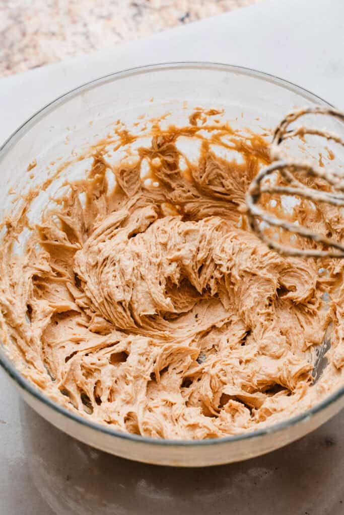 A bowl of the fluffy mixture after an egg is beaten into the butter and sugar.