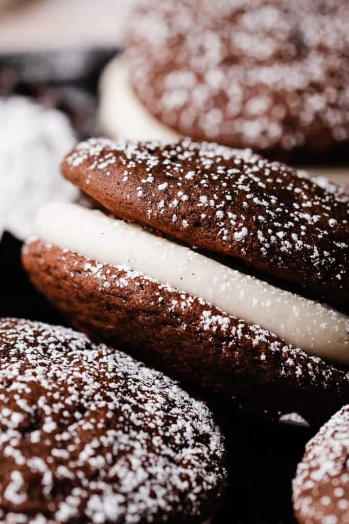A close-up on a whoopie pie, with a dusting of powdered sugar on top.