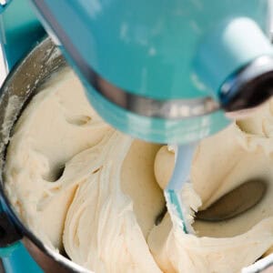The bowl of a stand mixer filled with luscious cream cheese frosting.