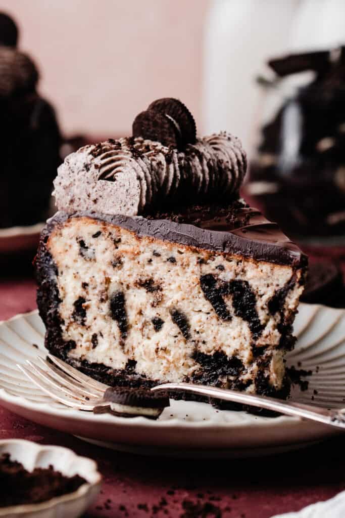 A slice of the oreo cheesecake on a plate.