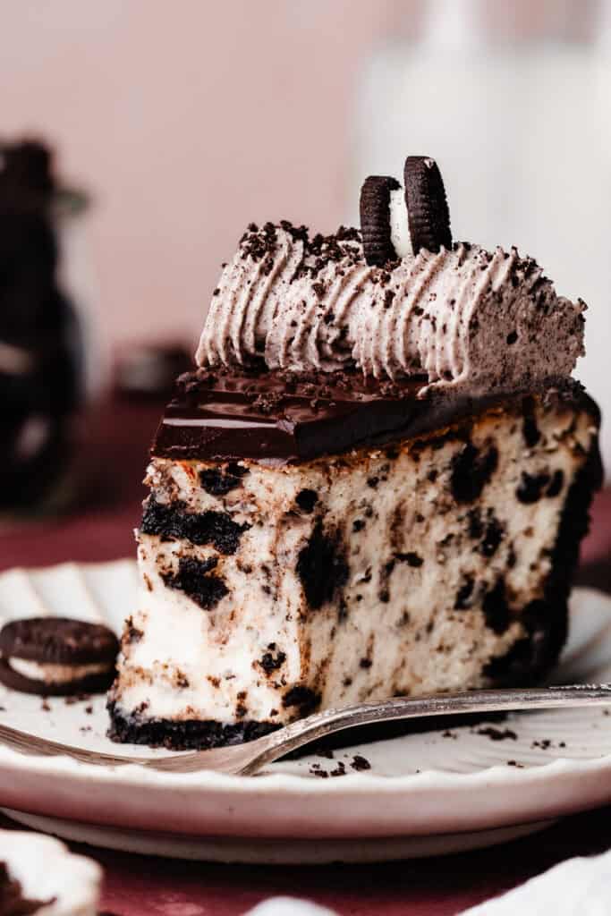 A close-up on a slice of the cheesecake with a few bites missing, to show the creamy texture inside.
