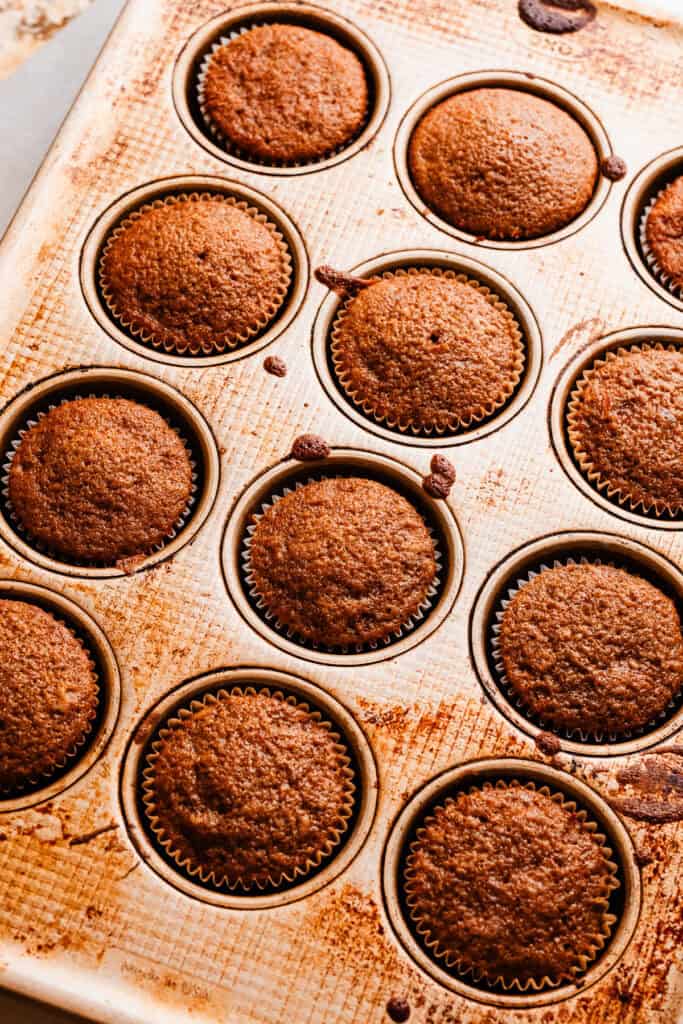 The baked carrot cake cupcakes cooling in the pan.