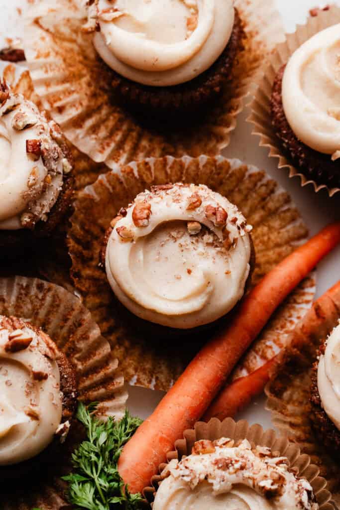 A bird's eye view of the frosted cupcakes, with beautiful swoops and crushed pecans on top.