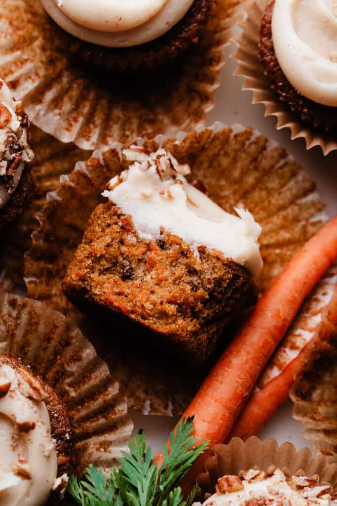 A bird's eye view of a cupcake with a bite missing, showing the fluffy texture inside.