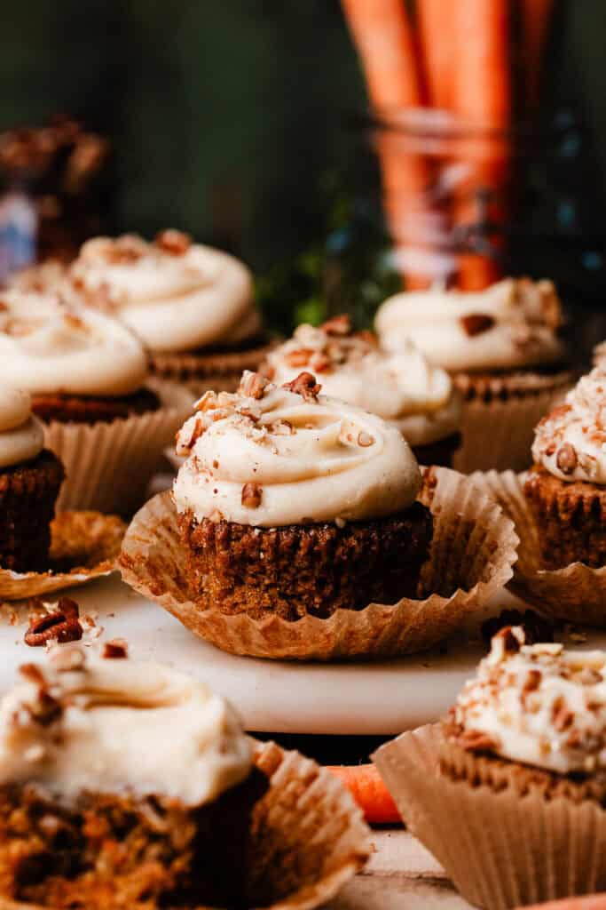 Cream Cheese Frosted Carrot Cake Cupcakes on a marble plate.