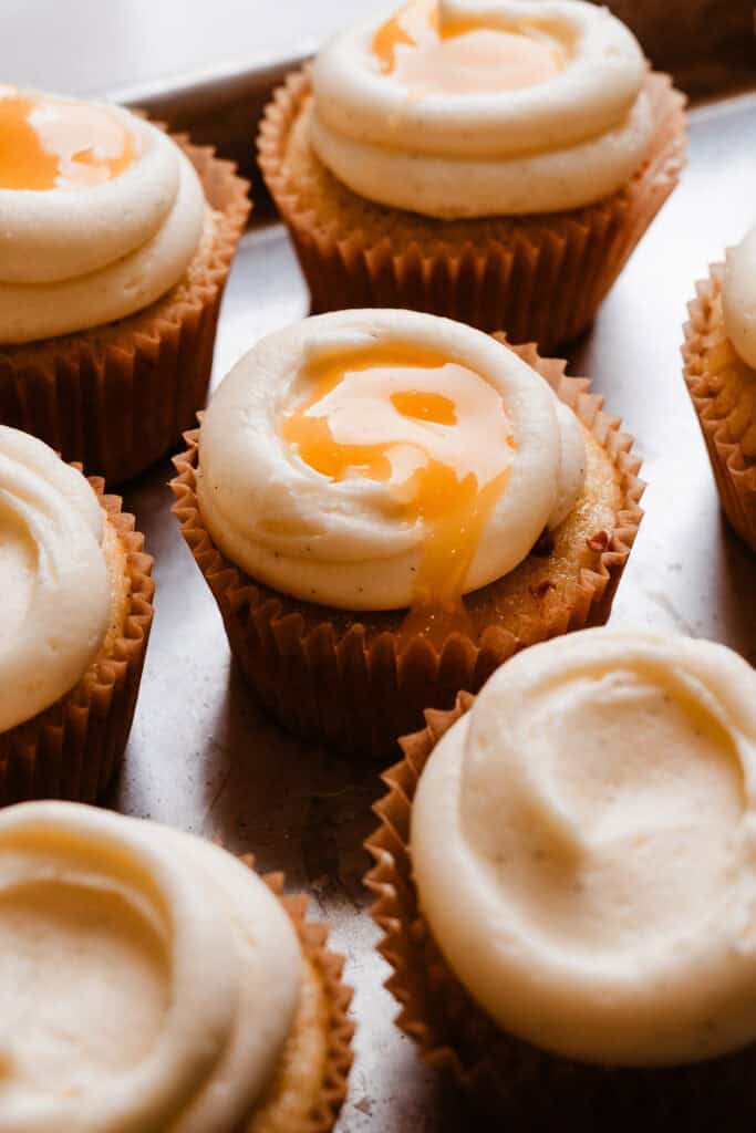 Frosted cupcakes, topped with extra lemon curd.