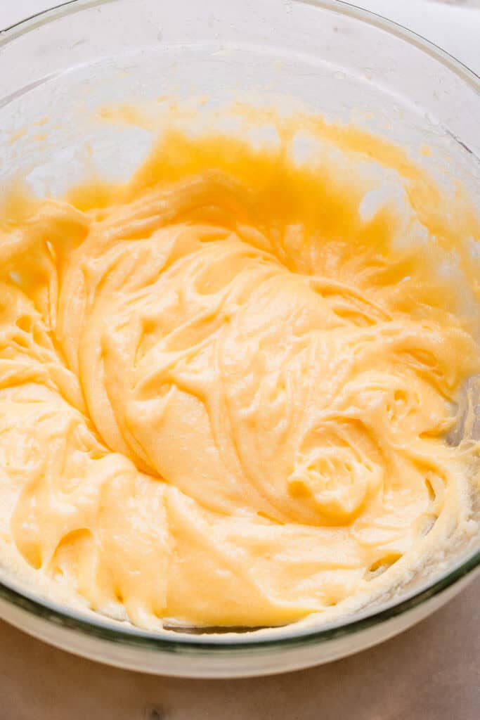 A bowl of the batter mixture after the butter, sugar, and eggs have been beaten together.