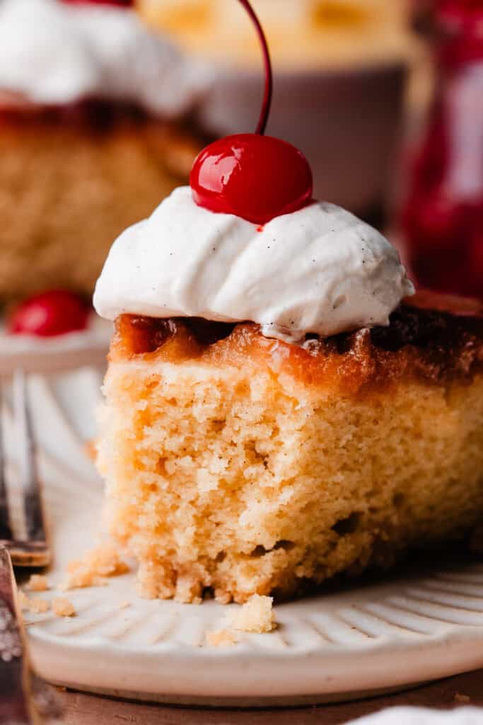 A close-up on a slice of the cake, with a bite missing.