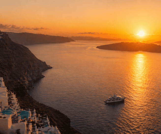 Beautiful sunset over Santorini's caldera with a cruise ship sailing in the sea. Perfect for sea and.