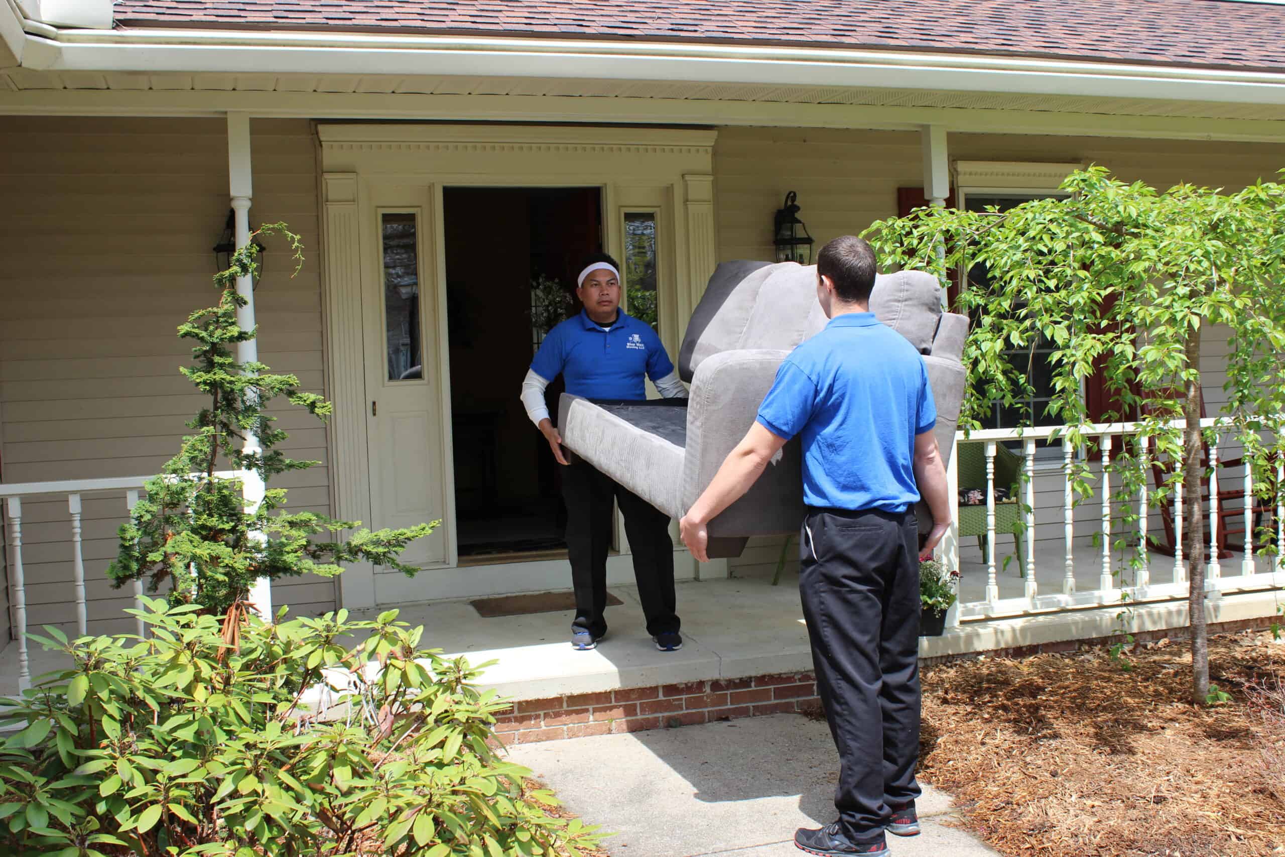 Moving company professionals transporting furniture during a local move in Akron, OH.