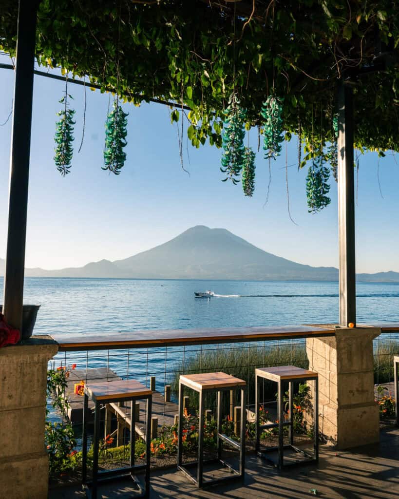 The view from the balcony of Free Cervesa hostel on Lake Atitlan in Guatemala with a Lancha speeding across the lake