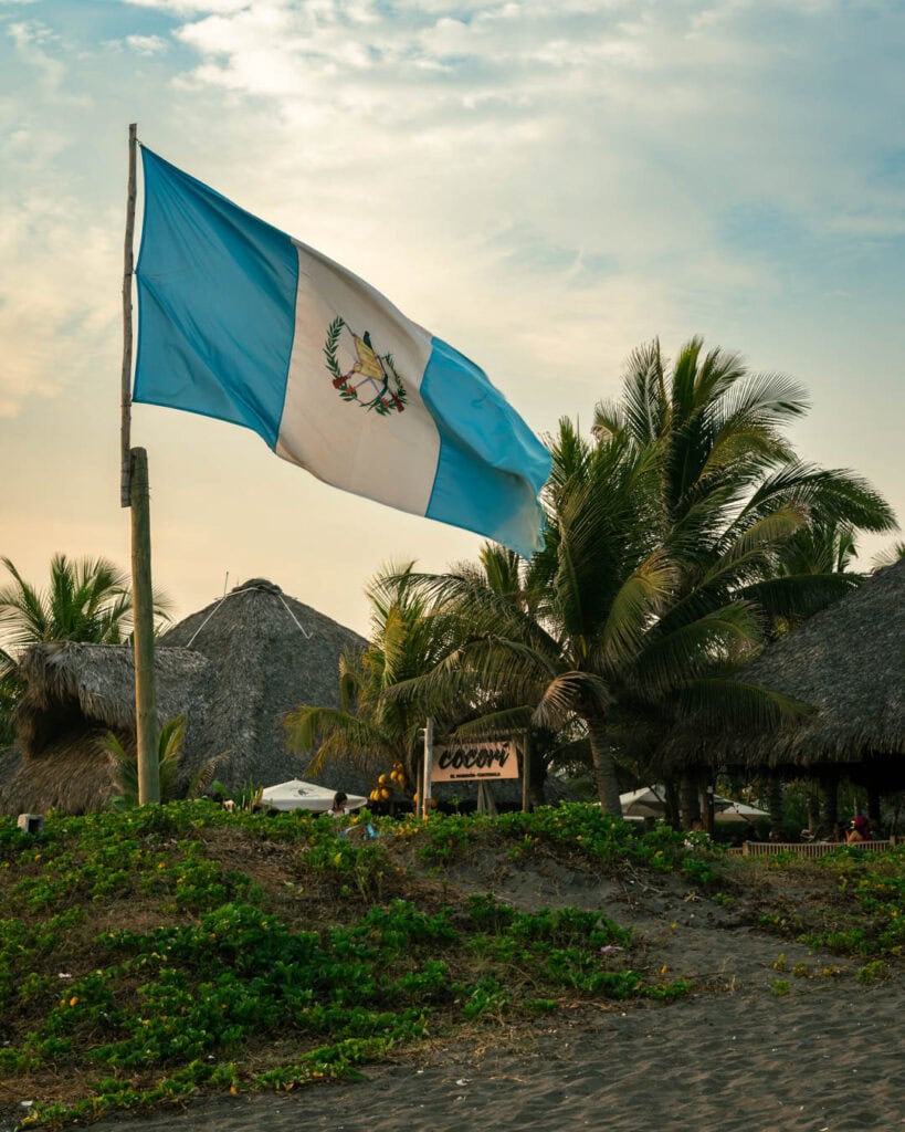 A giant Guatemalan flag waves infant of Cocori lodge's beachfront entrance in El Paredon Guatemala