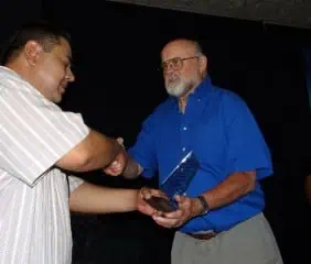 Bill Charland (right) receives a plaque on behalf of Border Partners from Principal Eduardo Esparza Rivota.
