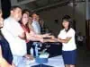 Proud graduate receives her certification from officials.