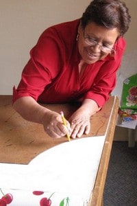A precision cut begins the process of creating an apron from Mexican oilcloth.