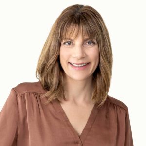 A confident woman smiling, representing mental clarity and focus, showcasing the benefits of brain performance technology for enhanced cognitive function.