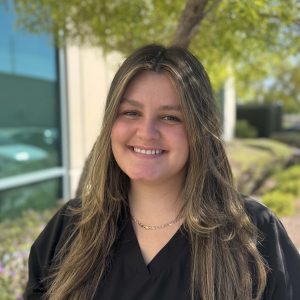 Bright smiling young woman outdoors, representing brain performance training, mental focus, and cognitive enhancement.