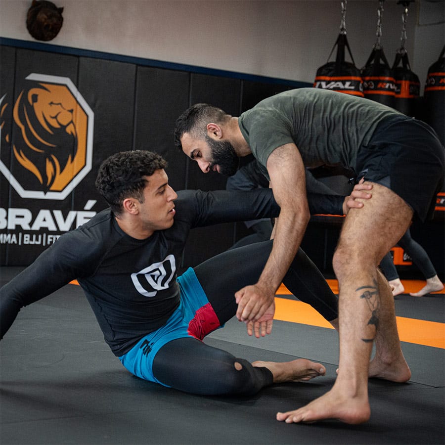 Intense Brazilian Jiu-Jitsu training session at Bravé MMA and Fitness gym.