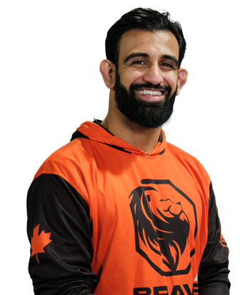 Male athlete smiling in sports jersey with lion logo.