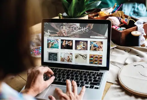 Person browsing DIY crafts website on laptop.