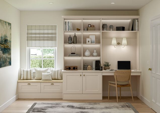 Sleek white built-in bookshelf with decorative vases, books, and a small workspace in a modern home office. Bright natural light and cozy seating area create an inviting atmosphere.