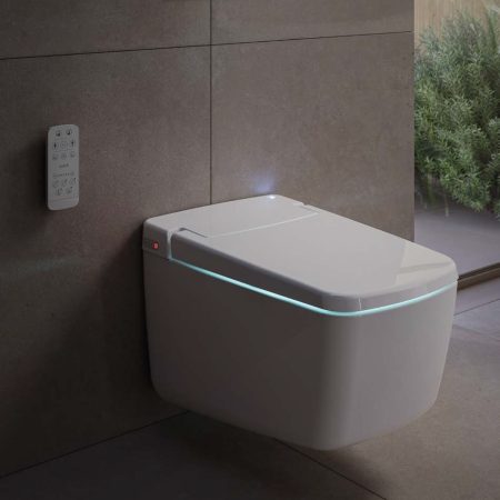 Modern smart toilet with sleek design and remote control in a contemporary bathroom setting.